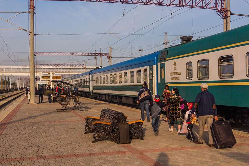 A railway platform with people boarding a train